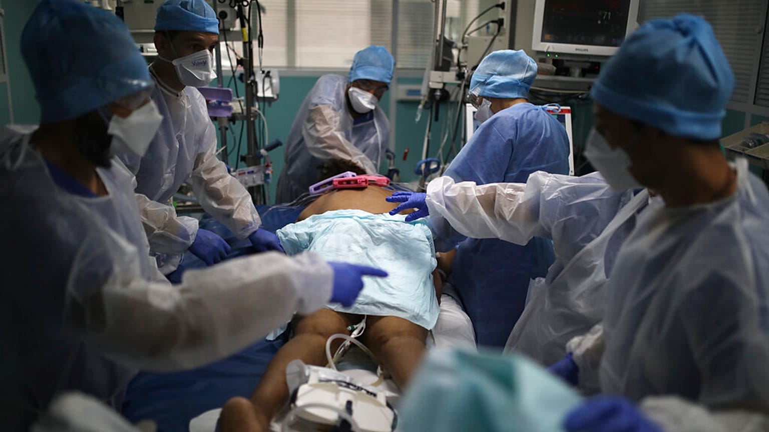 a medical crew gathers around a patient affected with COVID-19 in a Marseille hospital, southern France