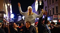 People drink in the street in the Soho area of London as COVID-19 restrictions are eased in step two of the government's roadmap out of England's third national lockdown