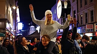 People drink in the street in the Soho area of London as COVID-19 restrictions are eased in step two of the government's roadmap out of England's third national lockdown