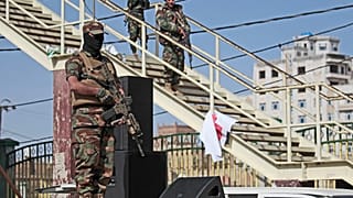 Houthi fighters stand guard during a rally marking six years for a Saudi-led coalition in Sanaa, Yemen