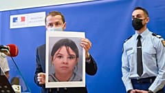 Der französische Staatsanwalt Nicolas Heitz hält ein Porträt der vermissten Mia Montemaggi während einer Pressekonferenz in Epinal