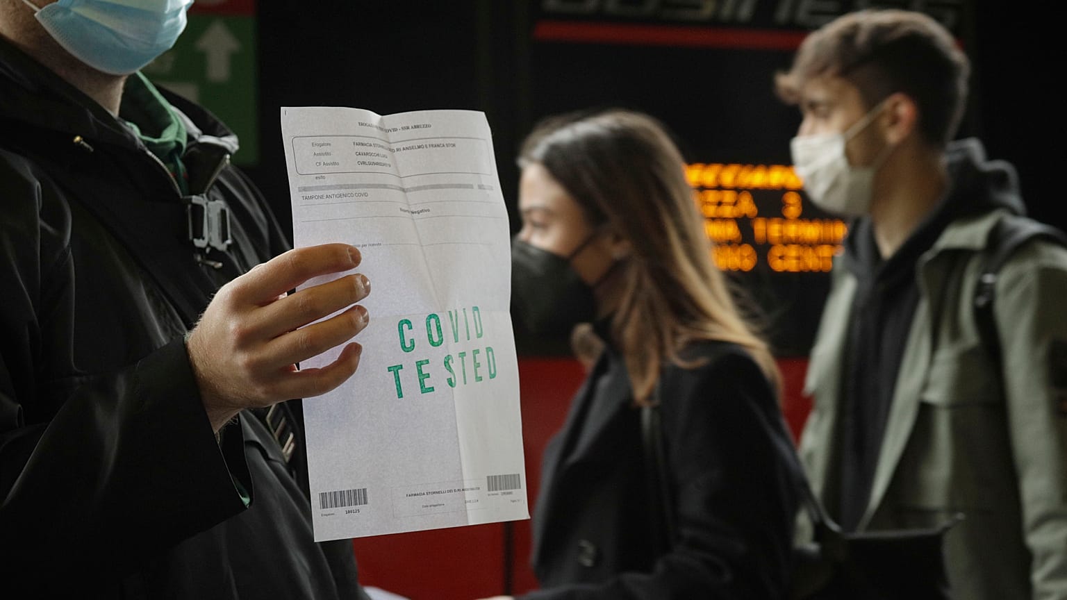 Pasajero mostrando el test negativo antes de subirse al tren