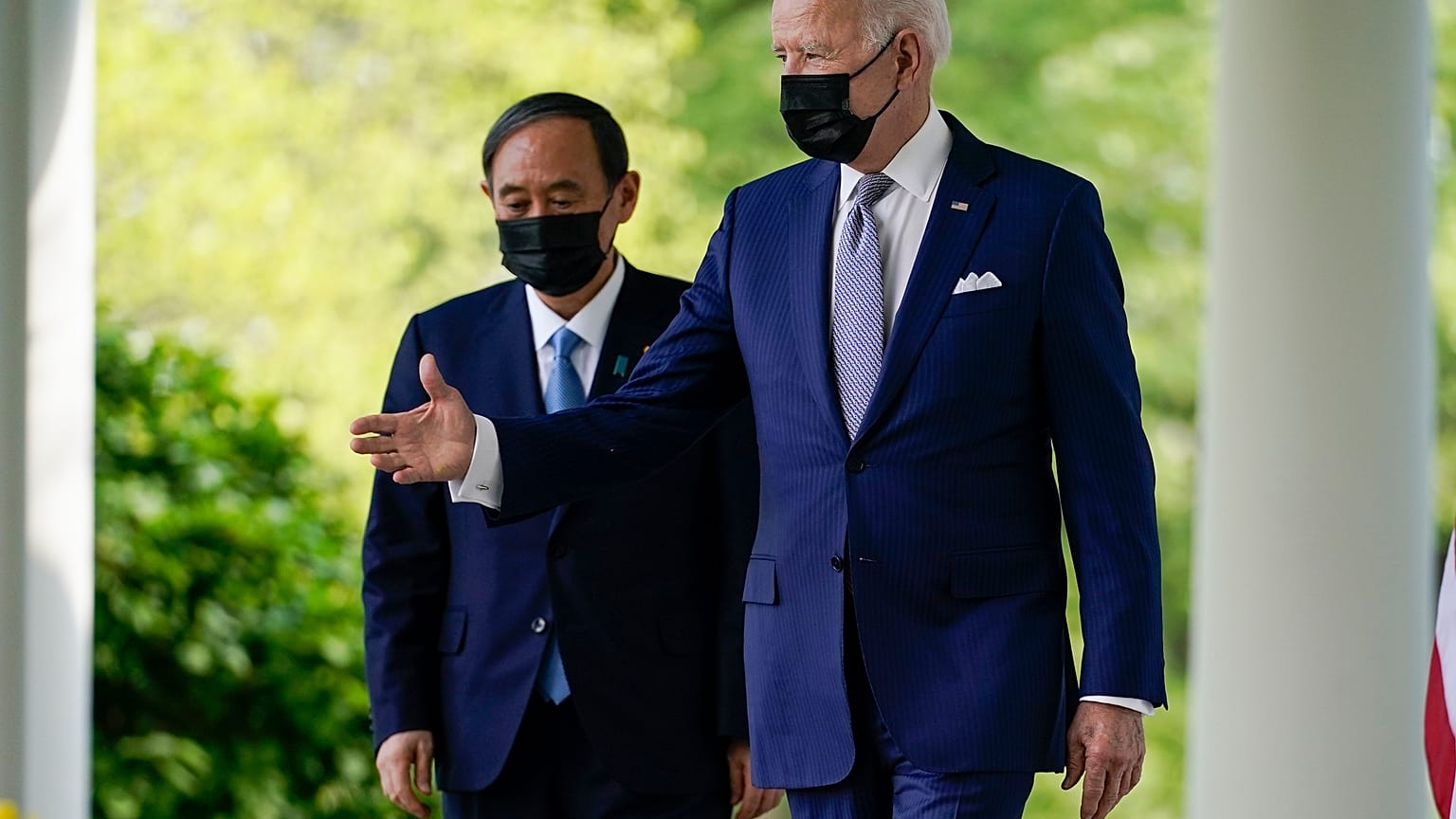 President Joe Biden, accompanied by Japanese Prime Minister Yoshihide Suga, walks from the Oval Office to speak at a news conference in the Rose Garden of the White House.
