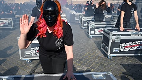 Entertainment workers bang on equipment cases during a flashmob performance called by the 'Bauli in Piazza' movement to protest against restrictions and closures.