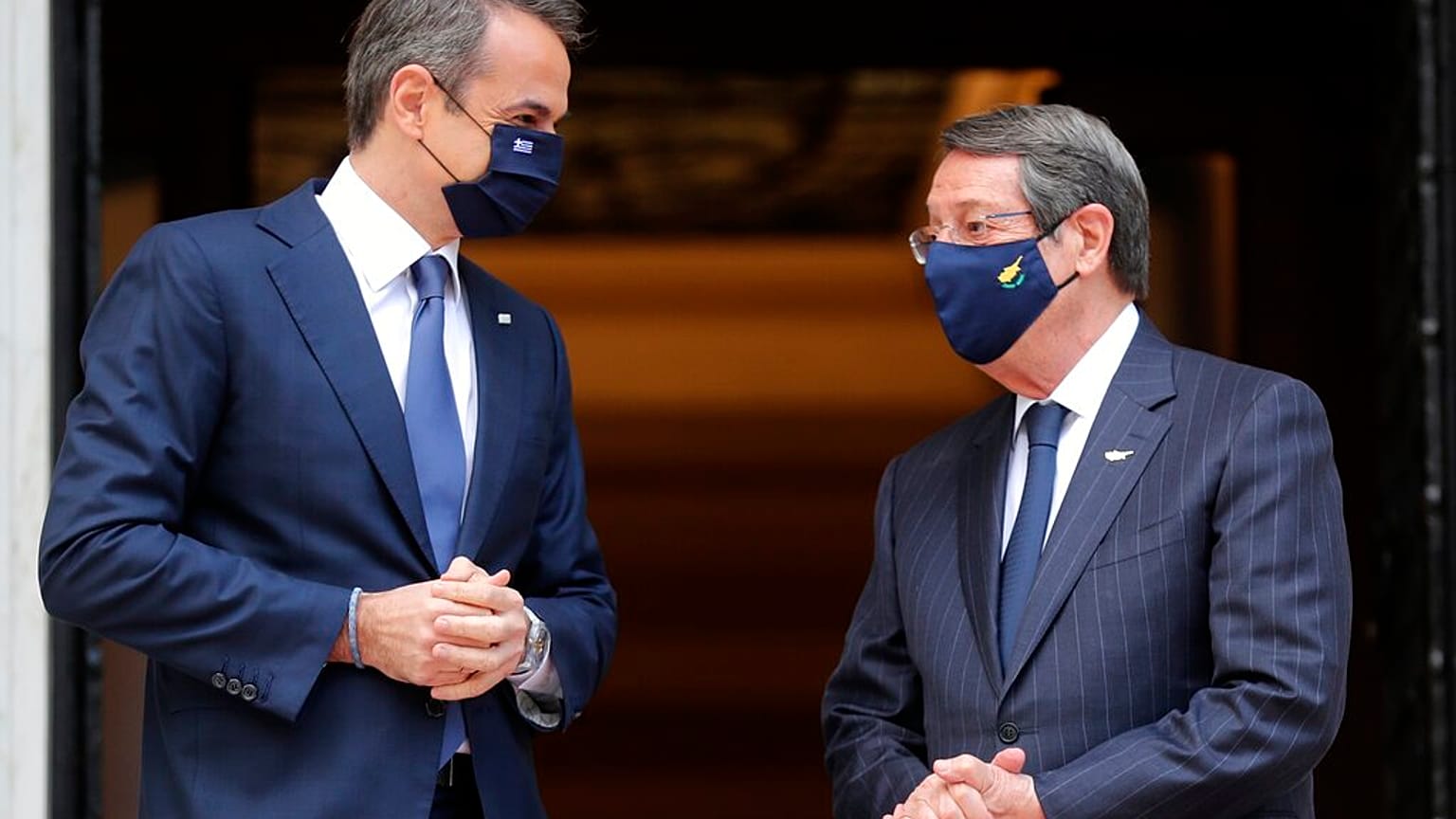 Greece's Prime Minister Kyriakos Mitsotakis, left, welcomes Cypriot President Nicos Anastasiades at Maximos Mansion in Athens,