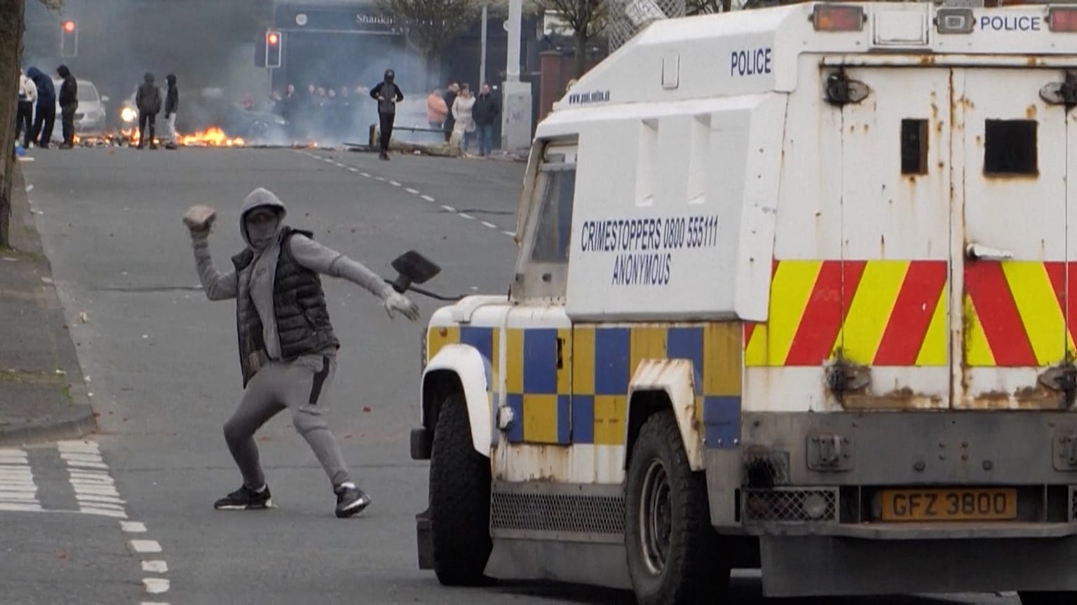 Youth attacking police vehicle