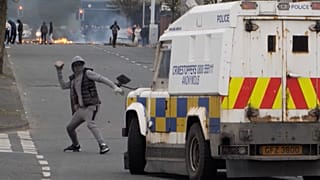 Youth attacking police vehicle