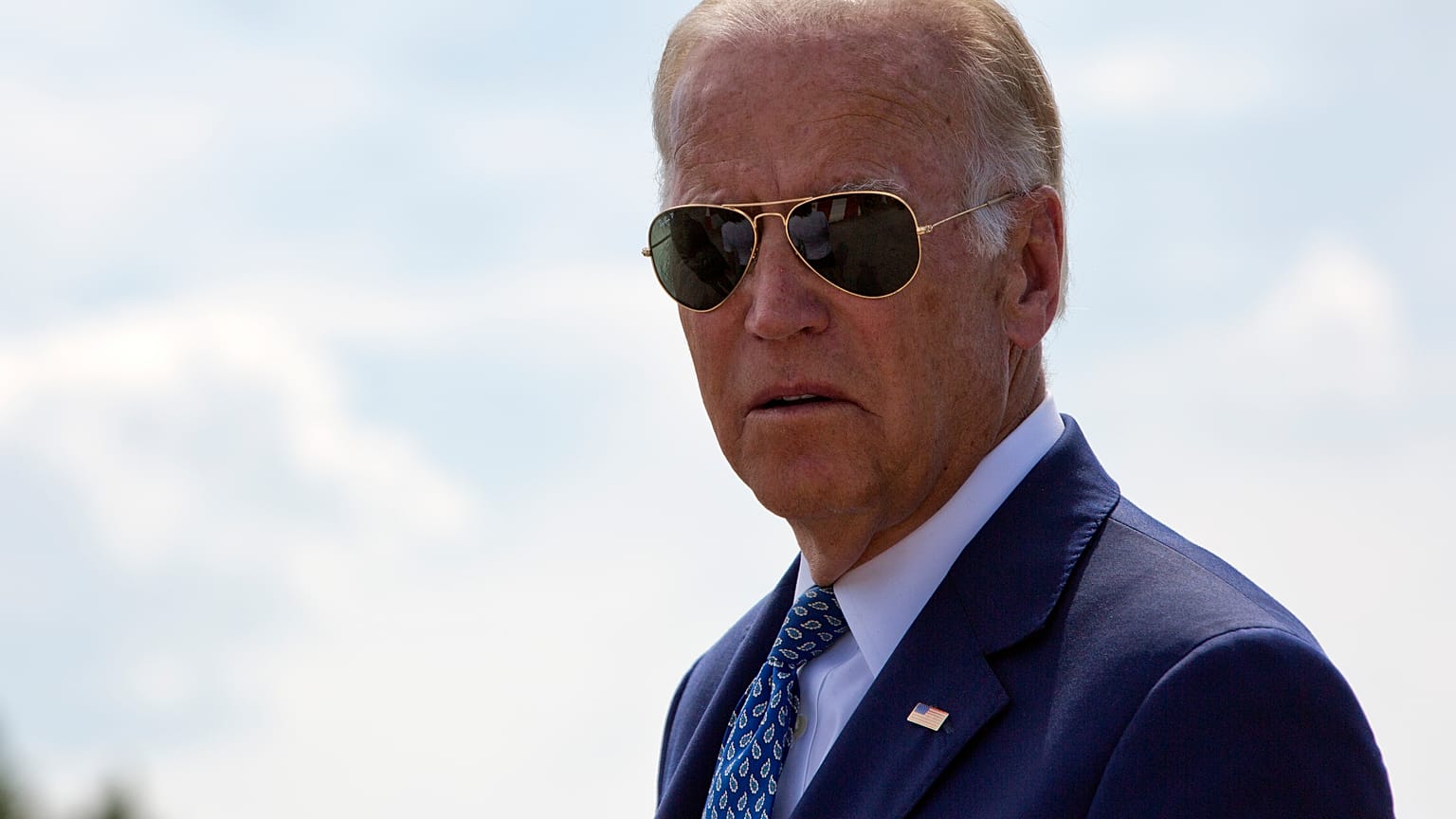 Joe Biden joined by his family members walk along the national road named after his late son in the village of Sojevo, Kosovo, on Wednesday, Aug. 17, 2016.