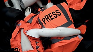 دمى عليها شارات وسترات صحفية تراكمت من قبل أعضاء منظمة مراسلون بلا حدود خلال احتجاج بمناسبة مرور عام على وفاة جمال خاشقجي.