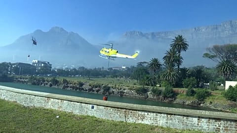 Helicopters collecting water from local reservoir
