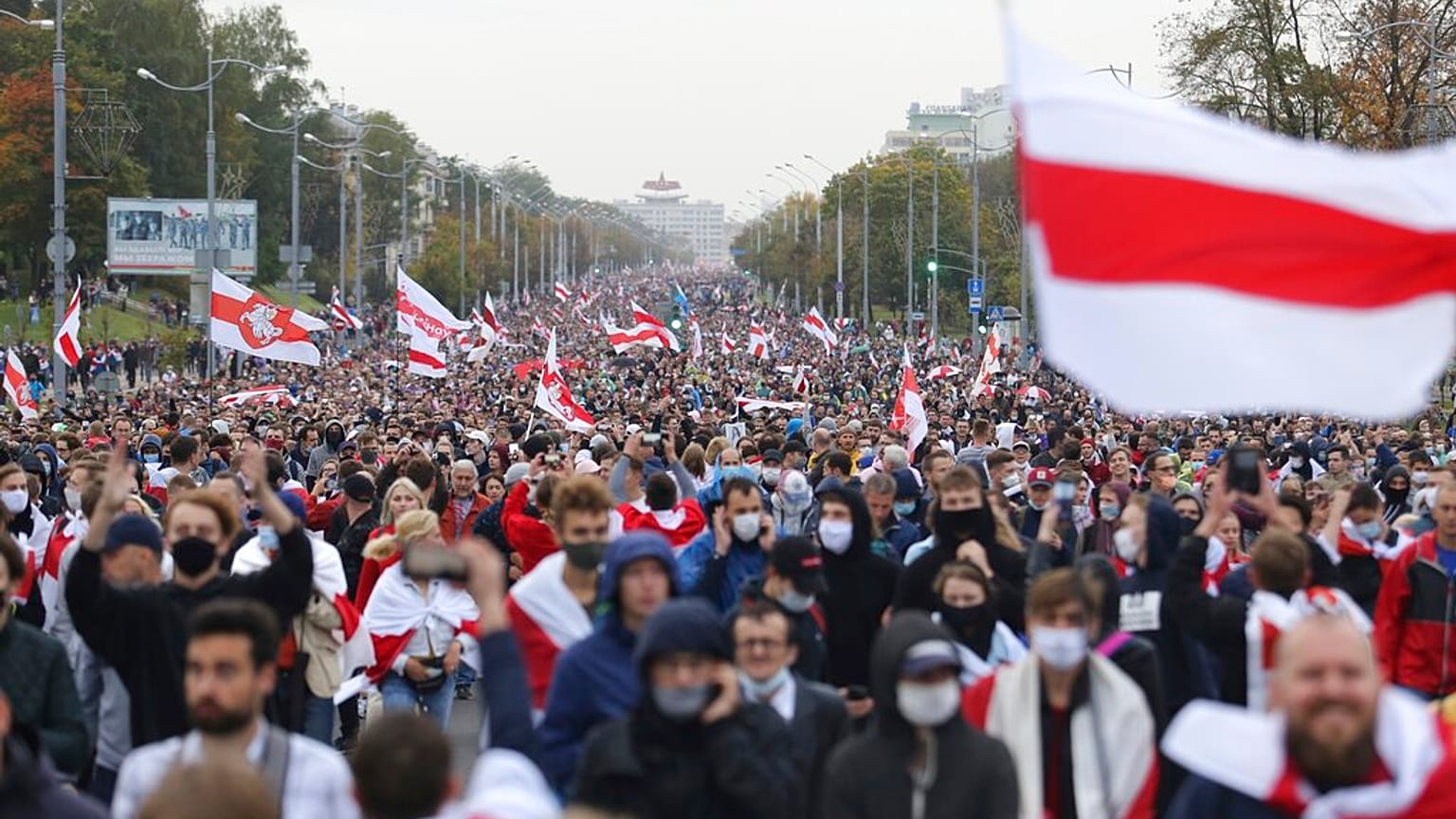 People with old Belarusian national flags march during an opposition rally to protest the official presidential election results in Minsk, Belarus, Sunday, Sept. 27, 2020.