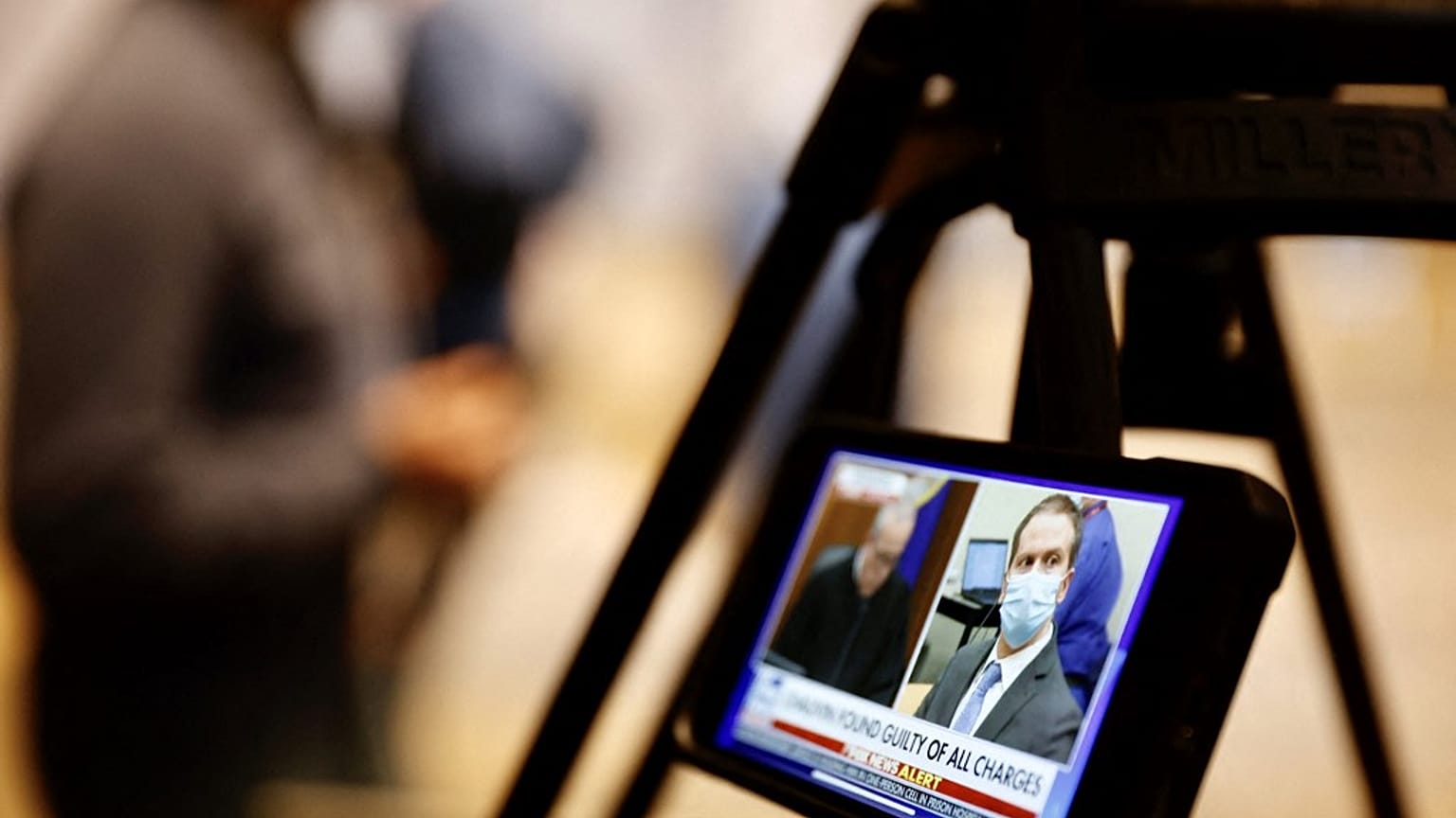 A journalist watches their mobile phone showing Derek Chauvin as the verdict in his trial over the death of George Floyd is announced in Minneapolis, USA on April 20, 2021