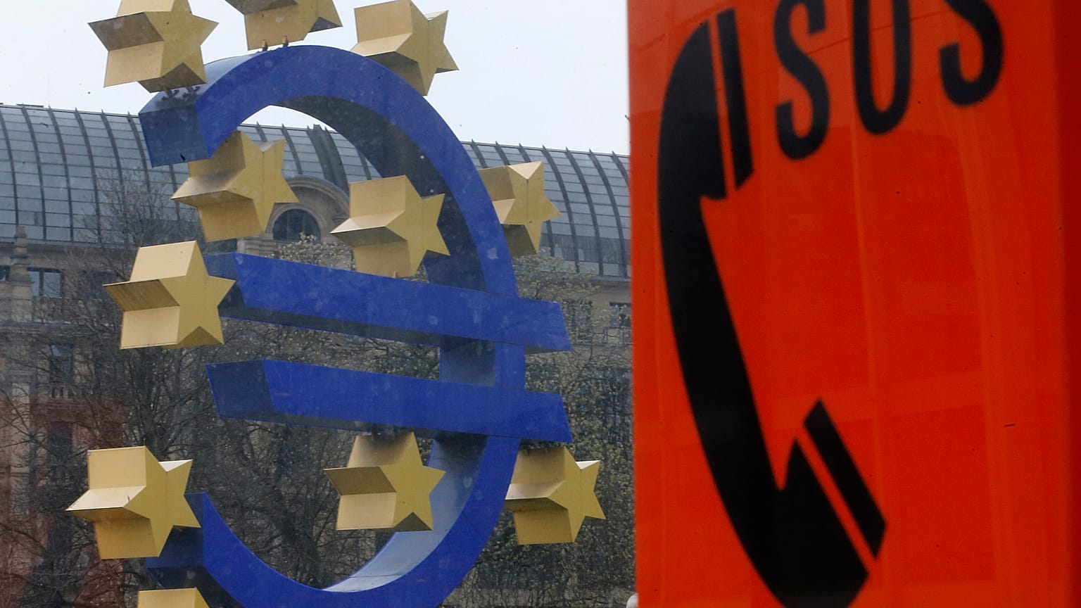 An emergency phone at a tram stop stands near the Euro sculpture in front of the European Central Bank in Frankfurt, Germany, March 18, 2014. 