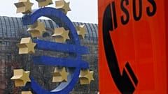 An emergency phone at a tram stop stands near the Euro sculpture in front of the European Central Bank in Frankfurt, Germany, March 18, 2014. 