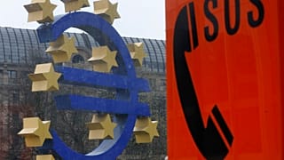 An emergency phone at a tram stop stands near the Euro sculpture in front of the European Central Bank in Frankfurt, Germany, March 18, 2014. 
