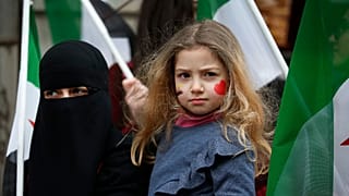 A child stands during a rally in Istanbul on Thursday, February 22, 2018, against attacks on the suburb of eastern Ghouta in Syria's capital Damascus.