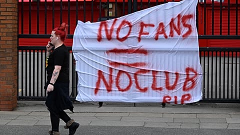 Banners critical of the European Super League project hang from the railings of Anfield stadium, Liverpool.
