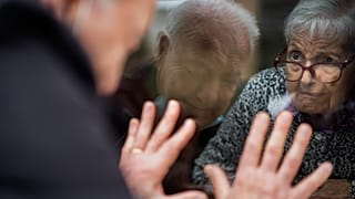 Javier Anto, 90, speaks to his wife Carmen Panzano, 92, through the window separating the nursing home from the street in Barcelona, Spain. April 21, 2021.
