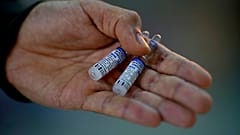 A volunteer vials of the Sputnik V COVID-19 vaccine
