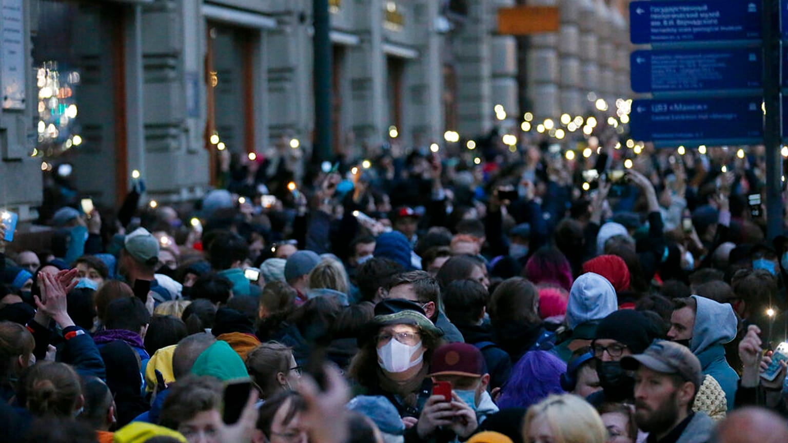 People light their phones during the opposition rally in support of jailed opposition leader Alexei Navalny in Moscow, Russia, Wednesday, April 21, 2021.