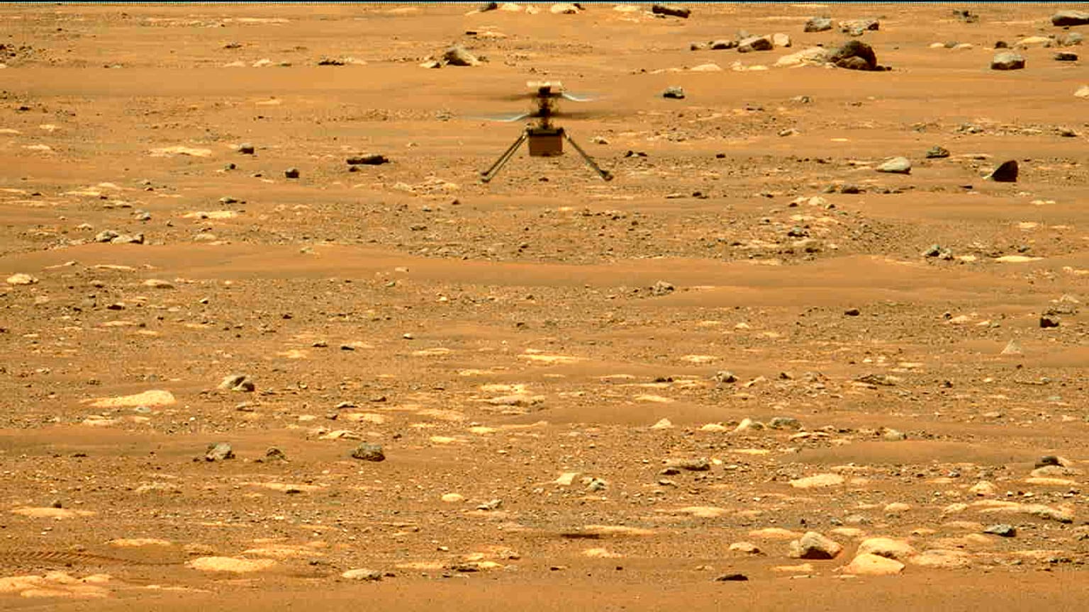 In this image made available by NASA, the Mars Ingenuity helicopter hovers above the surface of the planet during its second flight on Thursday, April 22