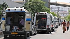 Ambulances carrying COVID-19 patients line up waiting for their turn to be attended at a dedicated COVID-19 government hospital in Ahmedabad, India