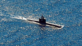 Indonesia's navy ships on Thursday were intensely searching for the submarine that likely fell too deep to retrieve, making survival chances for all the crew on board slim. 