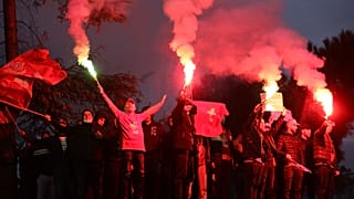 Supporters of the Socialist Movement for Integration (LSI) hold flares during a rally of their party in Tirana, Albania, Thursday, April 22, 2021.
