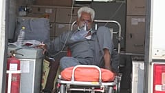 A COVID-19 patient waits inside an ambulance to be attended to and admitted into a dedicated COVID-19 government hospital in Ahmedabad, India.