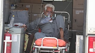 A COVID-19 patient waits inside an ambulance to be attended to and admitted into a dedicated COVID-19 government hospital in Ahmedabad, India.