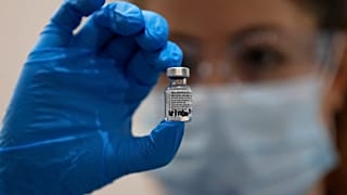 A nurse holds a phial of the Pfizer COVID-19 vaccine at Guy's Hospital in London, Tuesday, Dec. 8, 2020. 