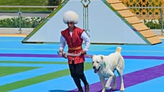 A man dressed in a national costume runs with his border guard shepherd dog Alabay during Dog Day celebration in Ashgabat, Turkmenistan, Sunday, April 25, 2021. 