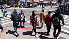 People walk on the street, Monday, April 26, 2021 in New York