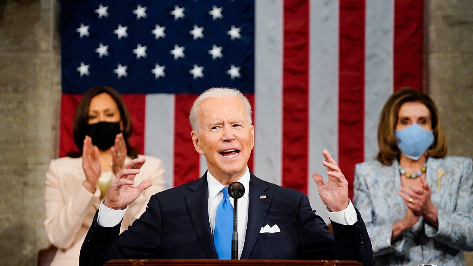 Vice President Kamala Harris, and House Speaker Nancy Pelosi of Calif., stand and applaud as President Joe Biden addresses a joint session of Congress. April 28, 2021.