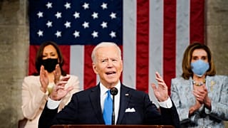 Vice President Kamala Harris, and House Speaker Nancy Pelosi of Calif., stand and applaud as President Joe Biden addresses a joint session of Congress. April 28, 2021.
