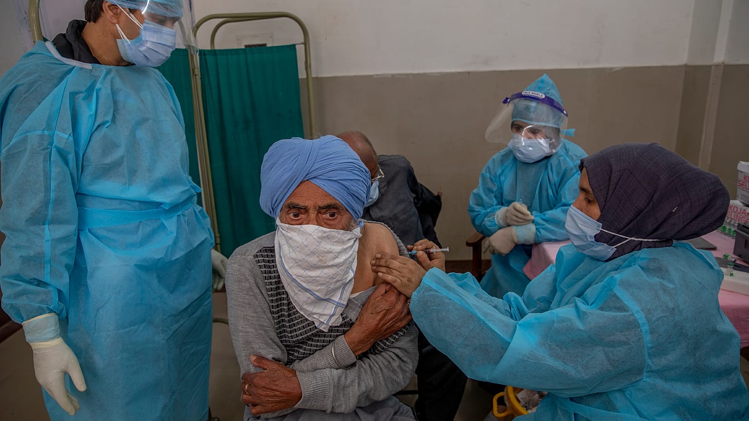 A man receives the COVISHIELD vaccine for COVID-19 at a primary health center in Srinagar, Indian controlled Kashmir, Wednesday, April 28, 2021.