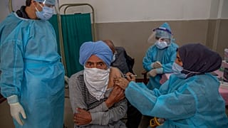 A man receives the COVISHIELD vaccine for COVID-19 at a primary health center in Srinagar, Indian controlled Kashmir, Wednesday, April 28, 2021.