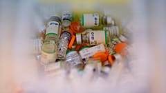 Empty vials of the Sputnik V COVID-19 vaccine and Sinopharm COVID-19 vaccine fill a container at Tecnopolis Park, in Buenos Aires, Argentina, April 15, 2021