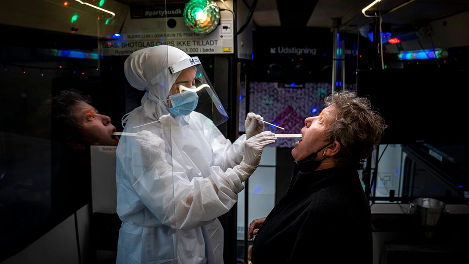 A person is tested inside a mobile coronavirus testing facility, in Ishoej, Denmark.