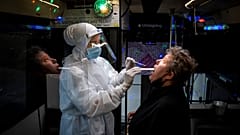 A person is tested inside a mobile coronavirus testing facility, in Ishoej, Denmark.