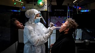 A person is tested inside a mobile coronavirus testing facility, in Ishoej, Denmark.