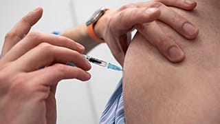 An employee of the Tuebingen Vaccination Centre inoculates a dose of Biontech vaccine in the Paul Horn Arena in Tuebingen, Germany, Wednesday, April 21, 2021.