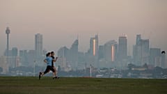 People exercise at a park as the sun rises in Sydney, Australia, Wednesday, April 28, 2021.