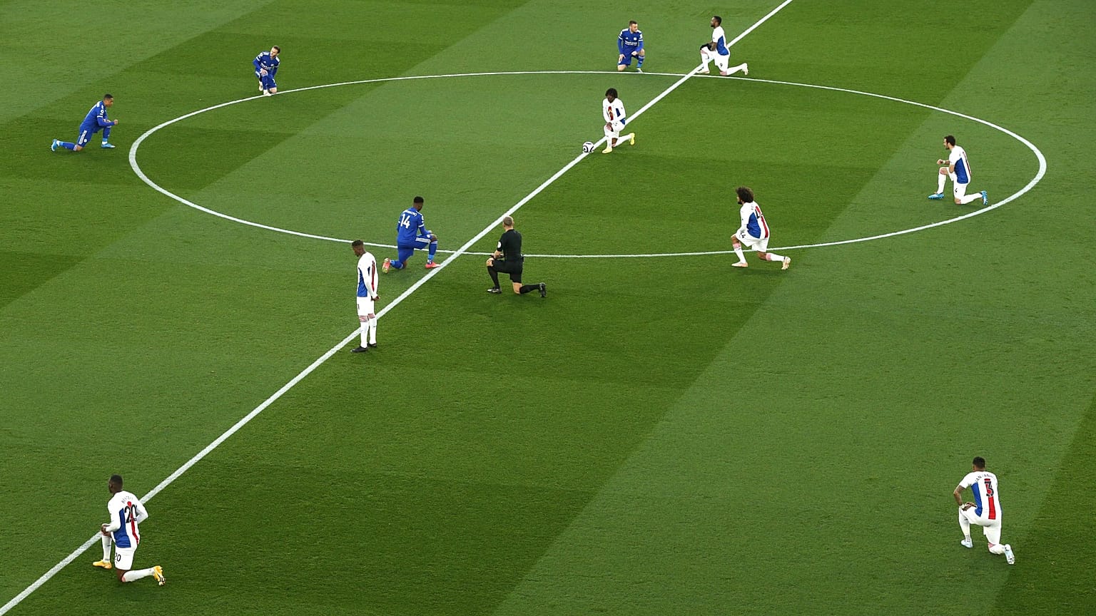 Players 'take a knee' in support of the No Room For Racism campaign ahead of the Leicester City vs Crystal Palace Premier League match on April 16, 2021.