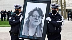 French police officers carry the portrait of Stephanie Monferme during the remembrance gathering in Rambouillet.