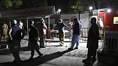 Afghans wait outside the hospital to see their relatives in Kabul, Afghanistan, Friday, April 30, 2021.