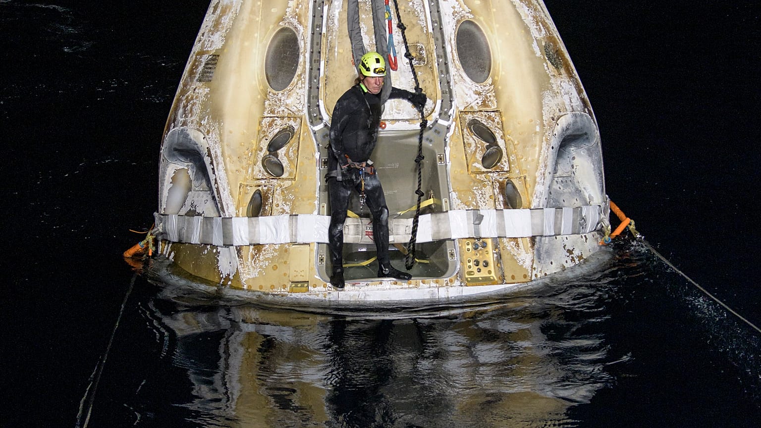 Support teams work around the SpaceX Crew Dragon Resilience spacecraft shortly after it landed in the Gulf of Mexico.