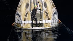 Support teams work around the SpaceX Crew Dragon Resilience spacecraft shortly after it landed in the Gulf of Mexico.