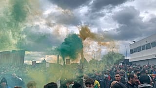 Manchester United fans hold flares as they protest outside of Old Trafford, during a protest against the Glazer family, owners of Manchester United, before their match.
