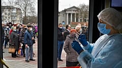 A Russian medical worker prepares a shot of Russia's Sputnik V coronavirus vaccine  as people queue for the jab in Simferopol, Crimea, April 13, 2021. 